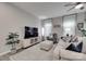 Bright living room features a neutral palette, a ceiling fan, and lots of natural light at 306 Willow Wood Ct, Matthews, NC 28104