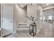 Carpeted staircase with wooden handrail and gray walls leading to the upper level at 306 Willow Wood Ct, Matthews, NC 28104