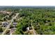 Aerial view showcasing home's setting among greenery, nearby road, and distant skyline at 308 Southland Rd, Huntersville, NC 28078