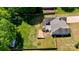 Aerial view of backyard with mature trees, shed, deck, and stone firepit at 308 Southland Rd, Huntersville, NC 28078