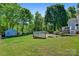 Lush backyard featuring a wooden deck, charming shed, and plenty of space for outdoor activities at 308 Southland Rd, Huntersville, NC 28078