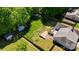 Aerial view of fenced backyard featuring deck, storage sheds, patio, and mature trees offering privacy at 308 Southland Rd, Huntersville, NC 28078