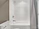 Modern tub and shower combination with white tile surround, great for a clean and relaxing bathroom experience at 308 Southland Rd, Huntersville, NC 28078
