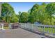 Spacious deck with bench seating provides the perfect spot to relax and enjoy the scenic backyard at 308 Southland Rd, Huntersville, NC 28078
