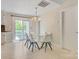 Bright dining area with a modern chandelier, and sliding glass door leading to outdoor area at 308 Southland Rd, Huntersville, NC 28078