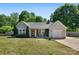 Charming single story home boasts a lovely landscaped yard, inviting front porch, and attached garage at 308 Southland Rd, Huntersville, NC 28078