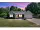 Charming single story home boasts a lovely landscaped yard, inviting front porch, and attached garage at 308 Southland Rd, Huntersville, NC 28078