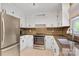 Updated kitchen features white cabinets, stainless steel appliances, and tile backsplash at 308 Southland Rd, Huntersville, NC 28078