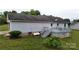 A view of a well-maintained back yard and wooden deck with seating at 3124 Banks St, Lincolnton, NC 28092