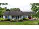 Charming single-story home with blue shutters, covered porch, and well-maintained landscaping at 3124 Banks St, Lincolnton, NC 28092