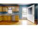 Bright kitchen area with wood cabinets, stainless steel dishwasher, and access to the deck at 3124 Banks St, Lincolnton, NC 28092