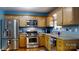 Well-equipped kitchen with stainless steel appliances, light wood cabinetry, and blue walls at 3124 Banks St, Lincolnton, NC 28092