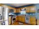 Functional kitchen featuring stainless steel appliances, wood cabinets, and a window view at 3124 Banks St, Lincolnton, NC 28092