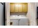 Convenient laundry area with washer, dryer, and overhead cabinets for storage at 3124 Banks St, Lincolnton, NC 28092