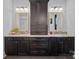 Bathroom with double vanity, dark wood cabinets, granite countertops and framed mirrors at 327 Kenway Loop, Mooresville, NC 28117