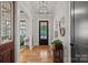 Inviting entryway featuring hardwood floors, stylish light fixtures, and tasteful decor, creating a warm ambiance at 327 Kenway Loop, Mooresville, NC 28117