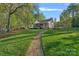 Charming home featuring a stone pathway, lush lawn, and inviting exterior at 327 Kenway Loop, Mooresville, NC 28117