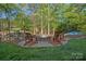 Outdoor fire pit area with Adirondack chairs, perfect for relaxing and entertaining near the lake at 327 Kenway Loop, Mooresville, NC 28117