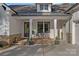 Charming front porch with stone accents, seating area, and a welcoming entrance to the home at 327 Kenway Loop, Mooresville, NC 28117