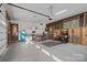 Spacious garage setup with kitchen area, bar seating, and multiple entertainment systems at 327 Kenway Loop, Mooresville, NC 28117