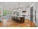 Bright, open kitchen with a large island, stainless steel appliances and views of a dining area at 327 Kenway Loop, Mooresville, NC 28117
