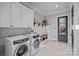Well-organized laundry room with modern washer and dryer, cabinetry, and convenient storage at 327 Kenway Loop, Mooresville, NC 28117
