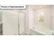 Bright bathroom featuring a soaking tub next to a window and a glass door shower at 3404 Lacebark Ln, Gastonia, NC 28056