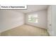 Carpeted bedroom with a window for natural light at 3404 Lacebark Ln, Gastonia, NC 28056