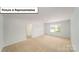 Open living room space with neutral carpet at 3404 Lacebark Ln, Gastonia, NC 28056