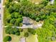 Drone shot of home nestled among trees, showcasing its expansive grounds and buildings at 4307 Edgeland Rd, Edgemoor, SC 29712