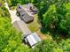 Aerial view of the home's roof, deck, garage, and firepit surrounded by lush green trees at 4307 Edgeland Rd, Edgemoor, SC 29712