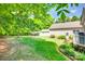 Lush backyard featuring a fire pit, covered storage, and well-maintained lawn at 4307 Edgeland Rd, Edgemoor, SC 29712
