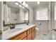 Bright bathroom features double sinks, framed mirror, natural light, and classic finishes at 4307 Edgeland Rd, Edgemoor, SC 29712