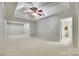 Spacious bedroom with a tray ceiling, ceiling fan and a carpeted floor, adjacent to the bathroom at 4307 Edgeland Rd, Edgemoor, SC 29712