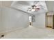 Large bedroom with carpeted floor, tray ceiling and fan, next to the ensuite bathroom with shelving at 4307 Edgeland Rd, Edgemoor, SC 29712