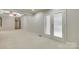 Large bedroom with carpeted floor, adjoining a space with shelving and an exterior door at 4307 Edgeland Rd, Edgemoor, SC 29712