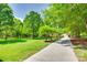 Long driveway through a lush green lawn with mature trees leading to the home and garage at 4307 Edgeland Rd, Edgemoor, SC 29712