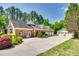 Charming brick home with well-manicured landscaping, a circular driveway, and a three-car garage at 4307 Edgeland Rd, Edgemoor, SC 29712
