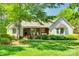 Charming single-story home with lush lawn, mature trees and a covered brick porch at 4307 Edgeland Rd, Edgemoor, SC 29712