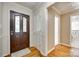 Inviting foyer featuring hardwood floors, crown molding, and a stylish front door with decorative glass at 4307 Edgeland Rd, Edgemoor, SC 29712