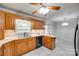 Spacious kitchen featuring wood cabinets, stone countertops, and black dishwasher at 4307 Edgeland Rd, Edgemoor, SC 29712