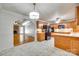 Open kitchen features wood cabinets, tile flooring, and an island, with a view to the living room at 4307 Edgeland Rd, Edgemoor, SC 29712