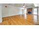Bright, open living room with hardwood floors, a brick fireplace, and French doors at 4307 Edgeland Rd, Edgemoor, SC 29712