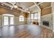 Light-filled living room features hardwood floors, a fireplace, and large windows for an airy feel at 4307 Edgeland Rd, Edgemoor, SC 29712