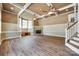 Spacious living room with hardwood floors, stone fireplace, and natural light from large windows at 4307 Edgeland Rd, Edgemoor, SC 29712