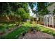 Lush backyard featuring a charming gazebo, a garden with blooming flowers, and a cozy fire pit area at 461 Pier Point Nw Ct, Concord, NC 28027
