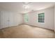 A spacious bedroom with neutral carpet and ample natural light from the two large windows at 461 Pier Point Nw Ct, Concord, NC 28027