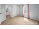 A bright bedroom featuring neutral carpet, a closet, and a private bathroom for convenience at 461 Pier Point Nw Ct, Concord, NC 28027