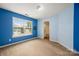 A blue bedroom featuring bright natural light, neutral carpet and an en suite bathroom at 461 Pier Point Nw Ct, Concord, NC 28027