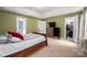 A well-lit bedroom featuring neutral carpet, a closet, and an attached bathroom for convenience at 461 Pier Point Nw Ct, Concord, NC 28027